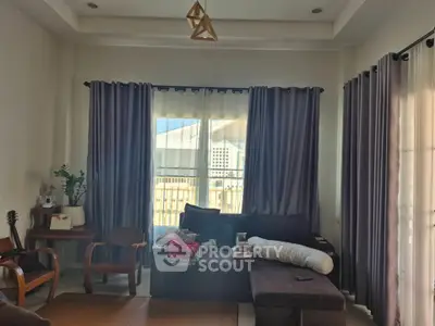 Cozy living room with modern furniture and large windows for natural light.