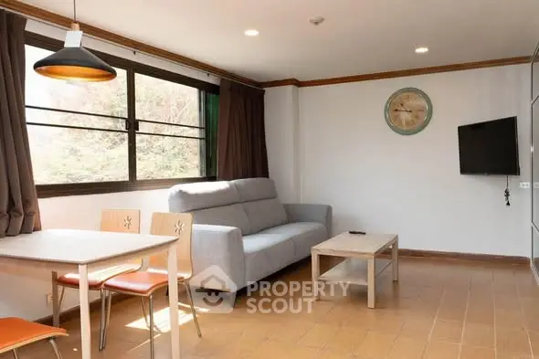 Bright living room with modern furniture and large window view