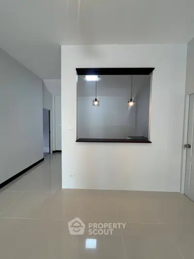 Modern interior with open layout and stylish pendant lights, perfect for contemporary living.