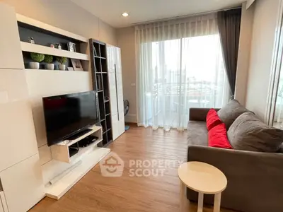 Modern living room with sleek furniture and large window offering city view.