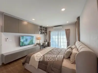 Modern bedroom with stylish decor and natural light, featuring a cozy bed and built-in storage.