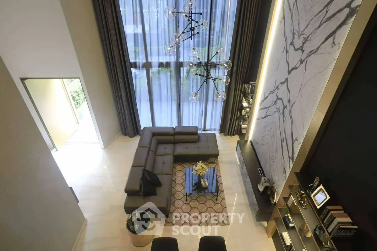 Luxurious modern living room with high ceiling and elegant decor