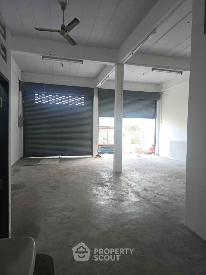 Spacious industrial warehouse with high ceilings and large roller doors