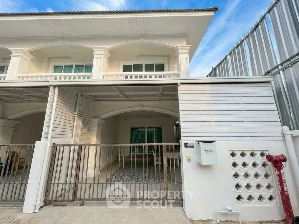 Charming two-story townhouse with gated entrance and spacious driveway