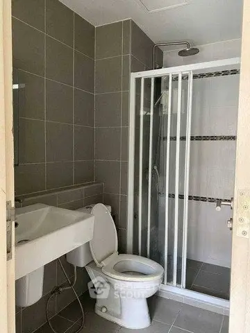 Modern bathroom with shower and sleek gray tiles