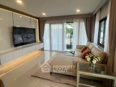 Luxurious living room with elegant decor and large windows offering natural light.