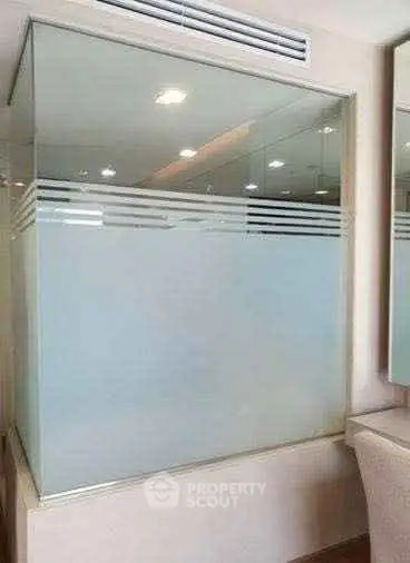 Modern bathroom with frosted glass partition and sleek design