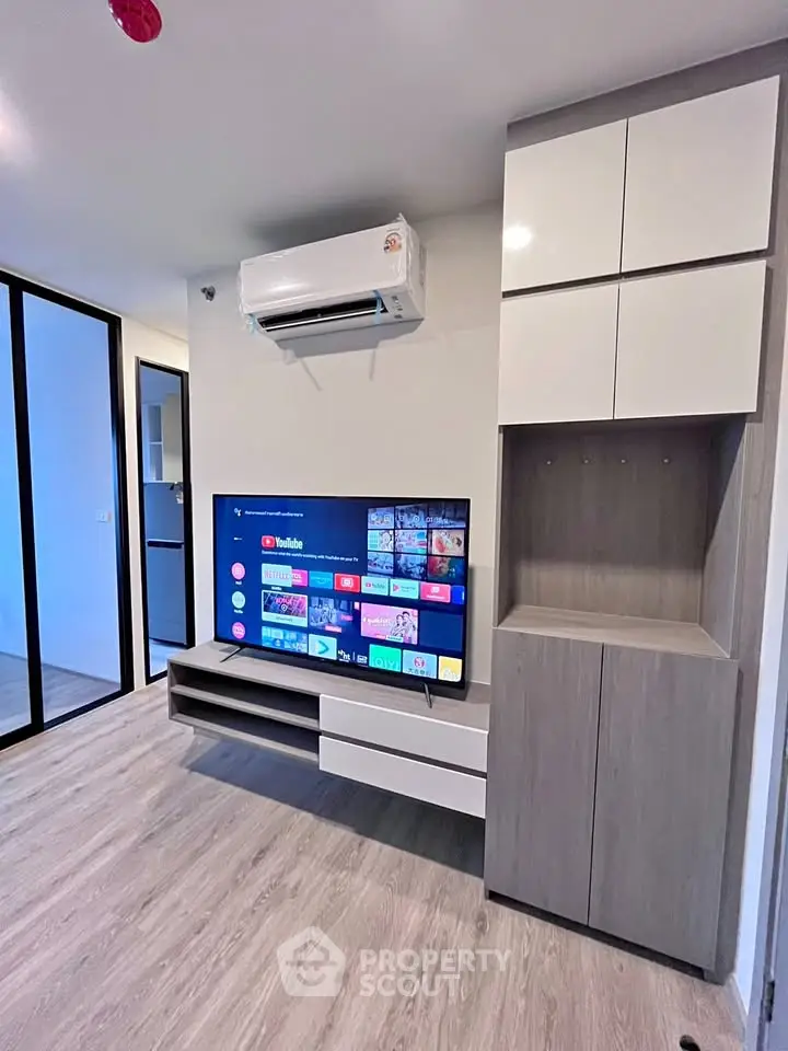 Modern living room with sleek TV unit and air conditioning