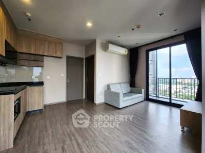 Spacious modern living room with balcony and city view, featuring sleek wooden flooring and contemporary design.