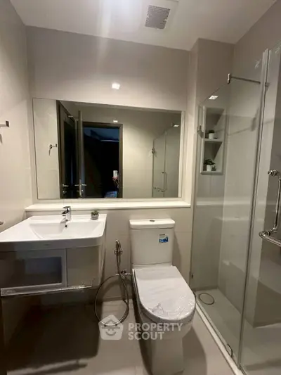 Modern bathroom with sleek fixtures and glass shower enclosure