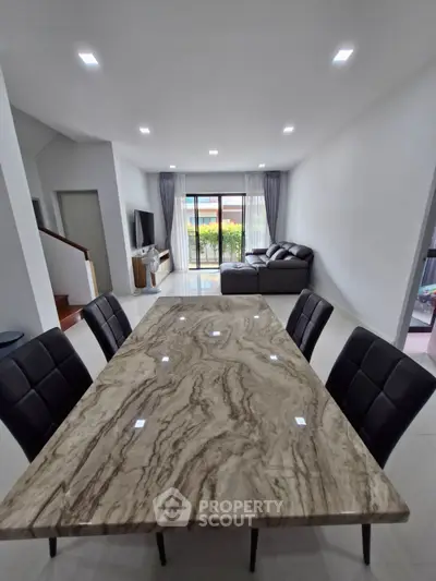 Spacious modern living room with elegant dining area and natural light