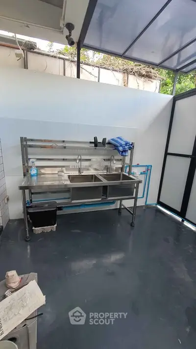 Spacious outdoor kitchen with stainless steel sink and modern design
