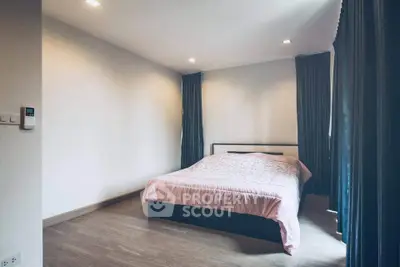 Spacious bedroom with modern decor and natural light