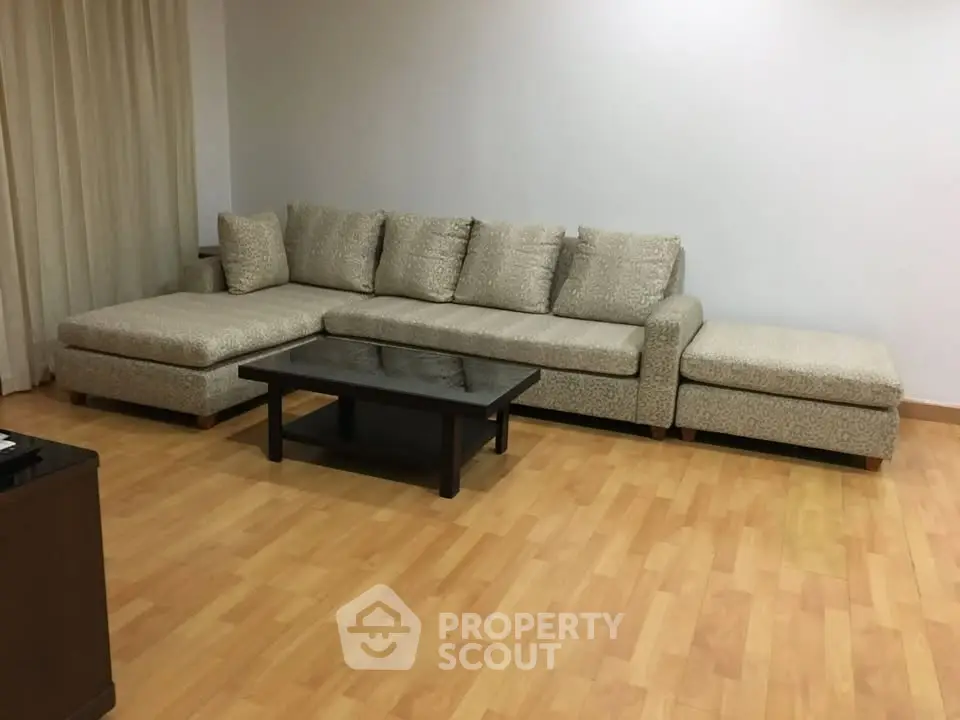 Spacious living room with elegant L-shaped sofa and wooden flooring
