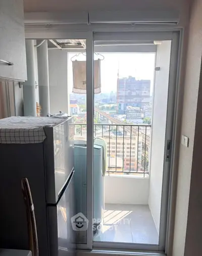 Compact balcony with city view and laundry area in modern apartment