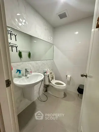 Modern bathroom with sleek white tiles and contemporary fixtures