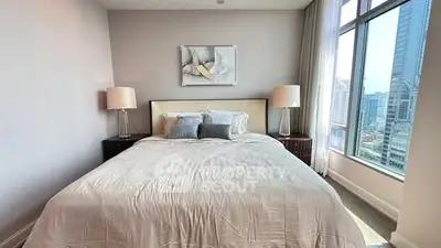 Luxurious bedroom with city view, featuring elegant decor and ample natural light.