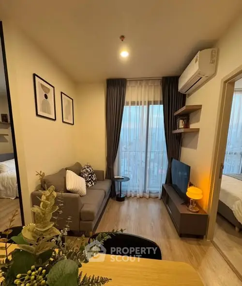 Modern living room with cozy decor and city view from window