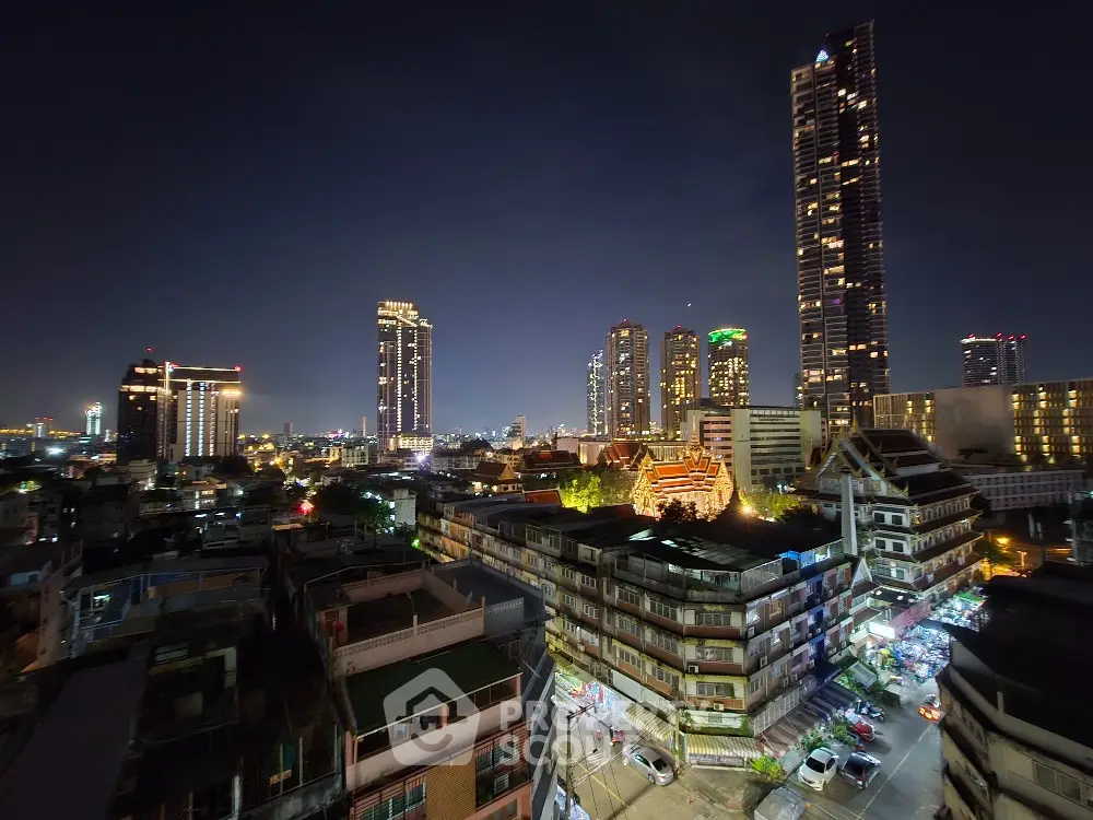 Stunning city skyline view with illuminated skyscrapers at night, perfect for urban living enthusiasts.