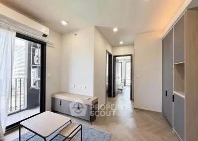 Modern living room with balcony access and sleek furniture in a contemporary apartment.