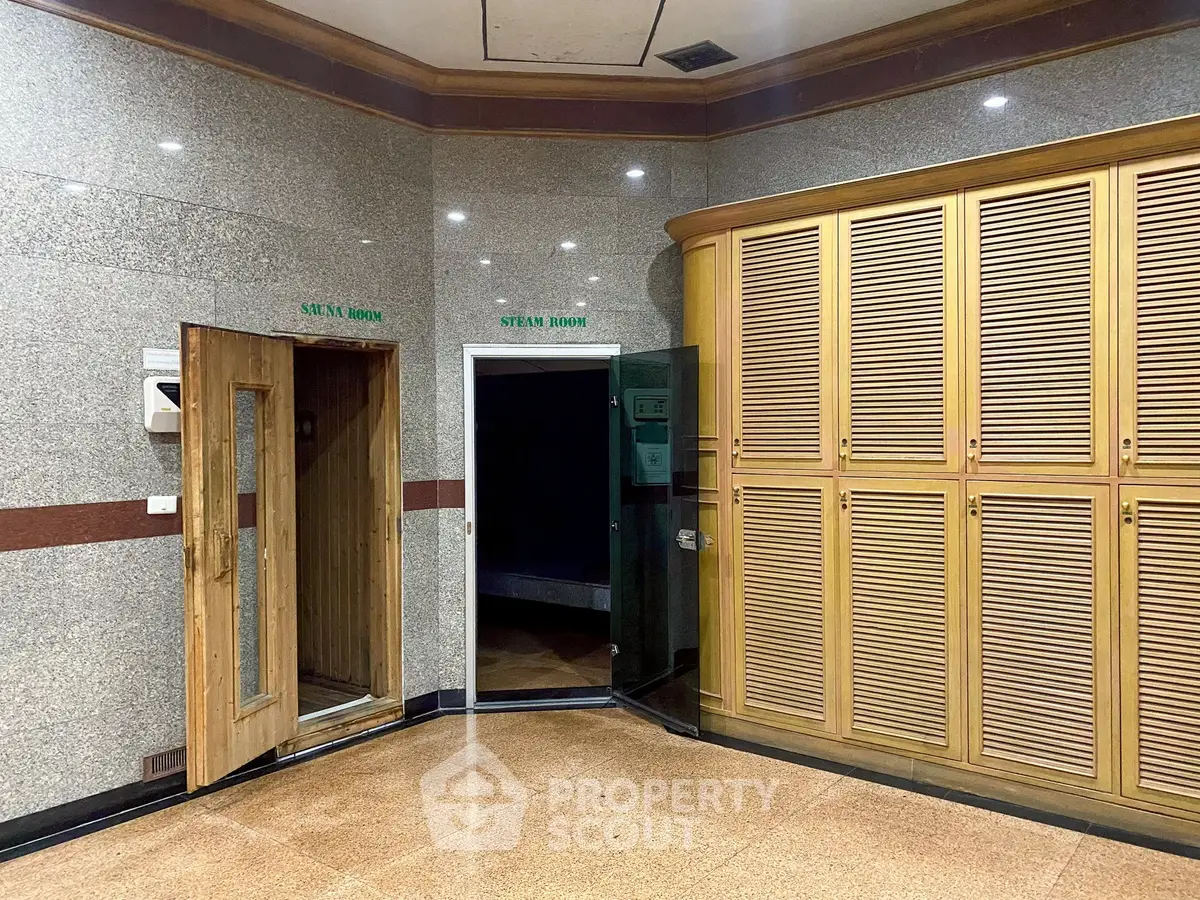 Luxurious sauna and steam room area with elegant wooden lockers and modern design.