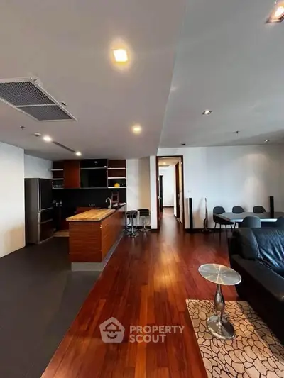 Spacious modern living room with open kitchen and hardwood floors
