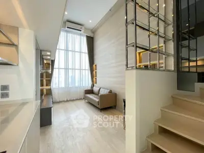 Modern living room with high ceiling and elegant staircase