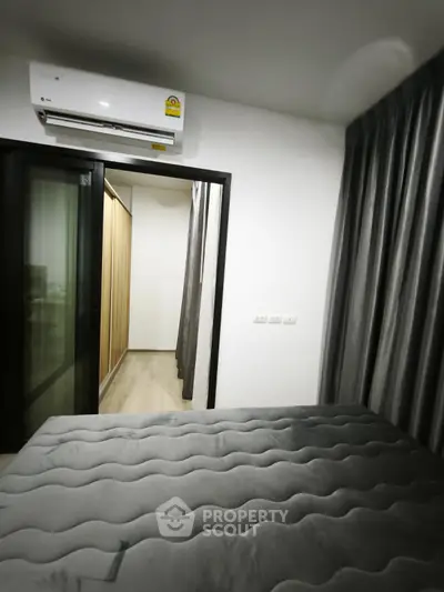 Modern bedroom with sleek design and air conditioning in a stylish apartment.