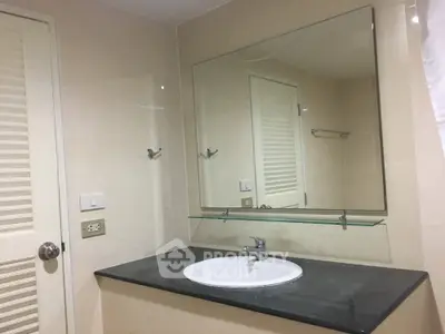 Modern bathroom with large mirror and sleek countertop