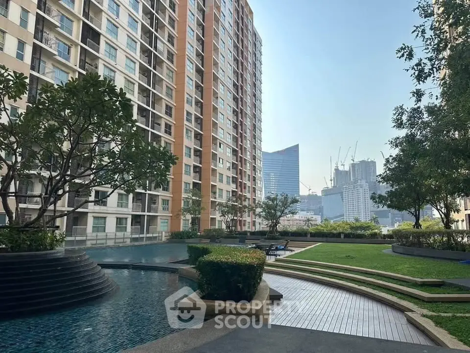 Luxurious urban apartment complex with pool and garden, offering stunning city views.