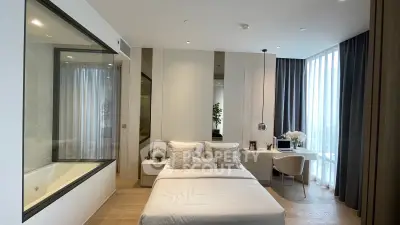 Luxurious modern bedroom with elegant decor and large window for natural light.