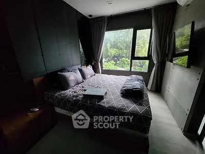 Cozy bedroom with large window and modern decor