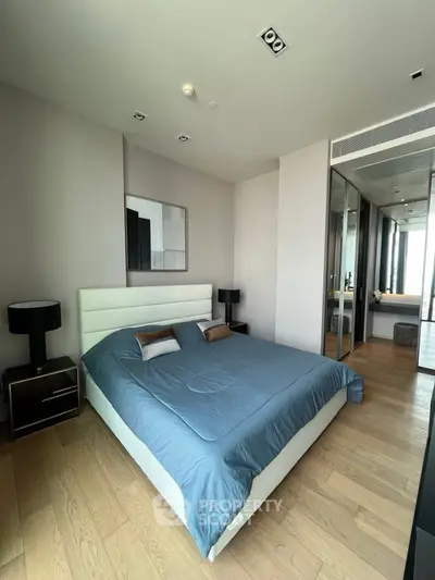 Modern bedroom with sleek design and hardwood floors in luxury apartment