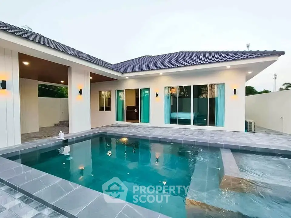 Modern villa with sleek pool and stylish exterior lighting, perfect for luxury living.