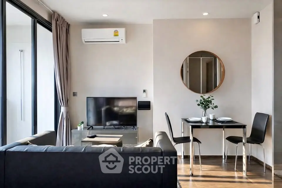 Modern living room with sleek furniture and dining area, featuring a wall-mounted TV and air conditioning.