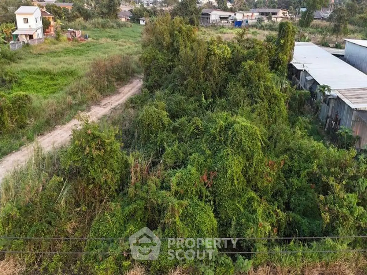 Expansive plot of land with lush greenery, ideal for development opportunities.