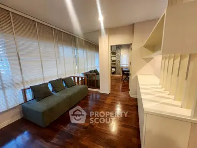 Spacious living room with elegant wooden flooring and modern decor