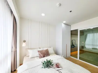 Modern bedroom with elegant decor and large window for natural light