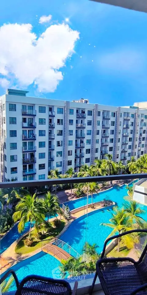 Stunning view of modern apartment complex with pool and lush greenery