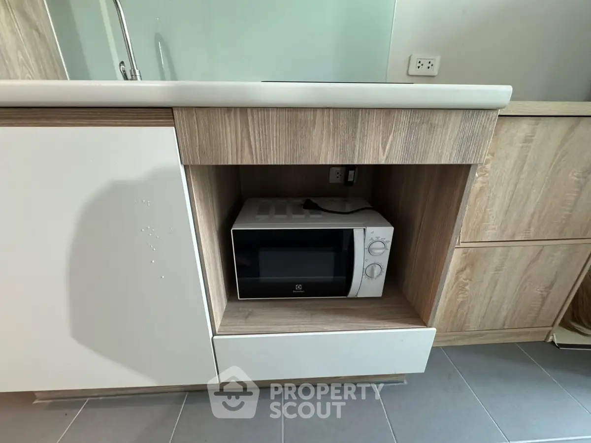 Modern kitchen with built-in microwave and sleek cabinetry