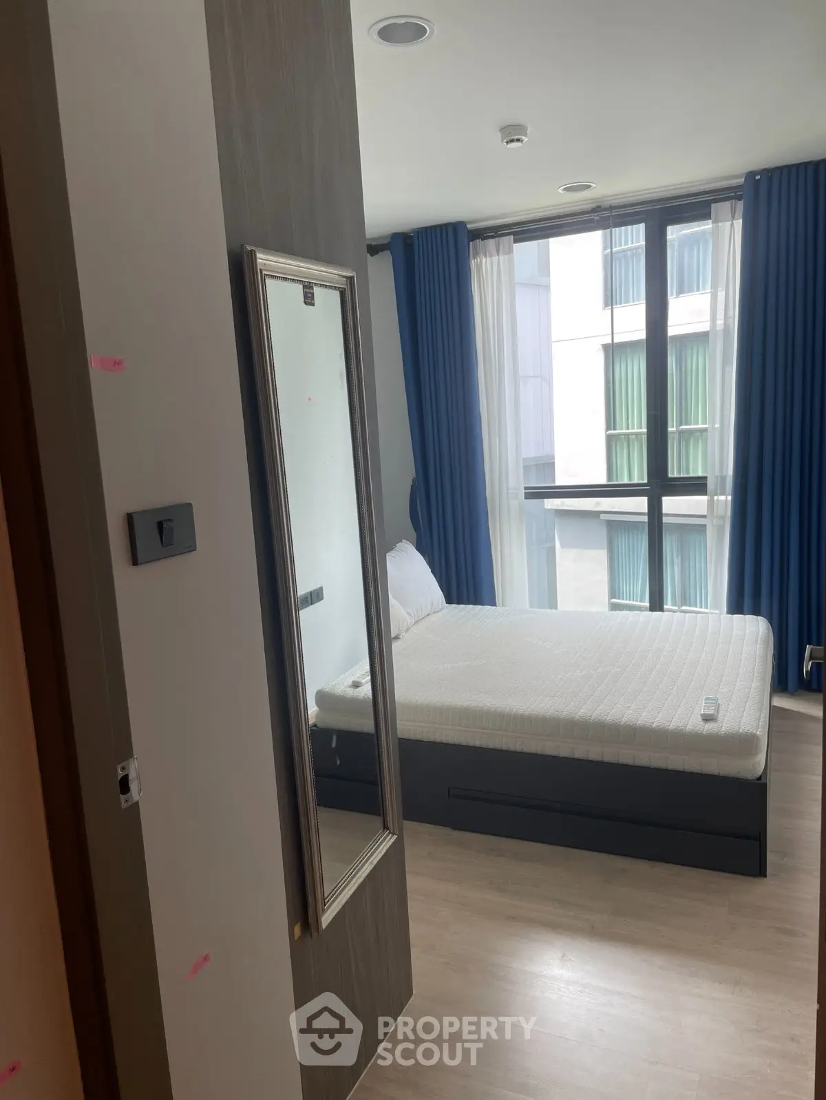 Modern bedroom with large window and stylish decor in urban apartment