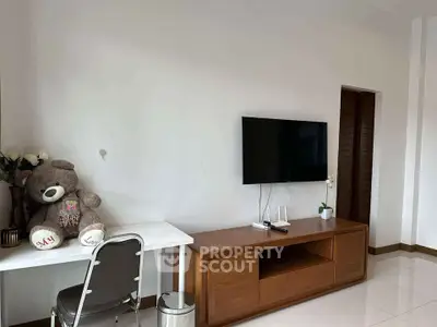 Modern living room with wall-mounted TV and stylish wooden furniture