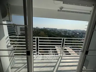 Spacious balcony with stunning city view in modern high-rise apartment