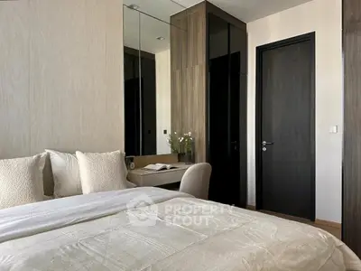Modern bedroom with elegant decor and cozy ambiance, featuring a stylish bed and sleek furniture.