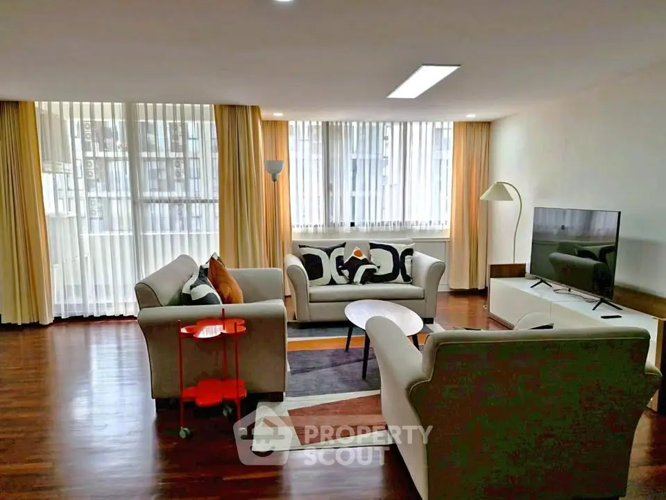 Spacious living room with modern furniture and large windows for natural light.