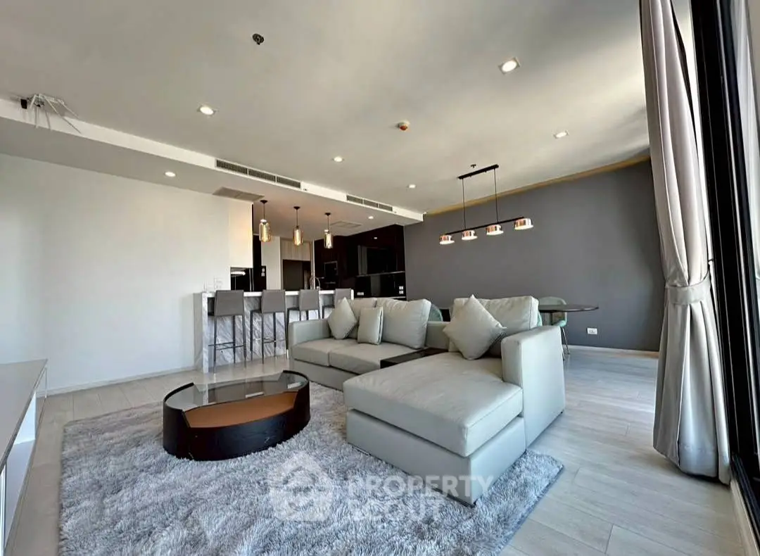 Spacious modern living room with open kitchen and elegant decor
