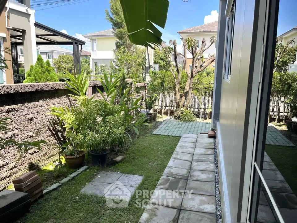 Charming garden view with lush greenery and modern exterior in a serene residential area.