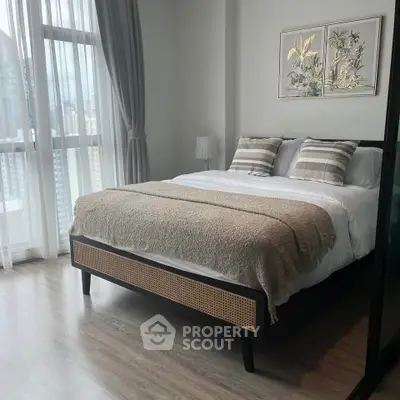 Elegant bedroom with city view, featuring a cozy bed and stylish decor in a modern apartment.