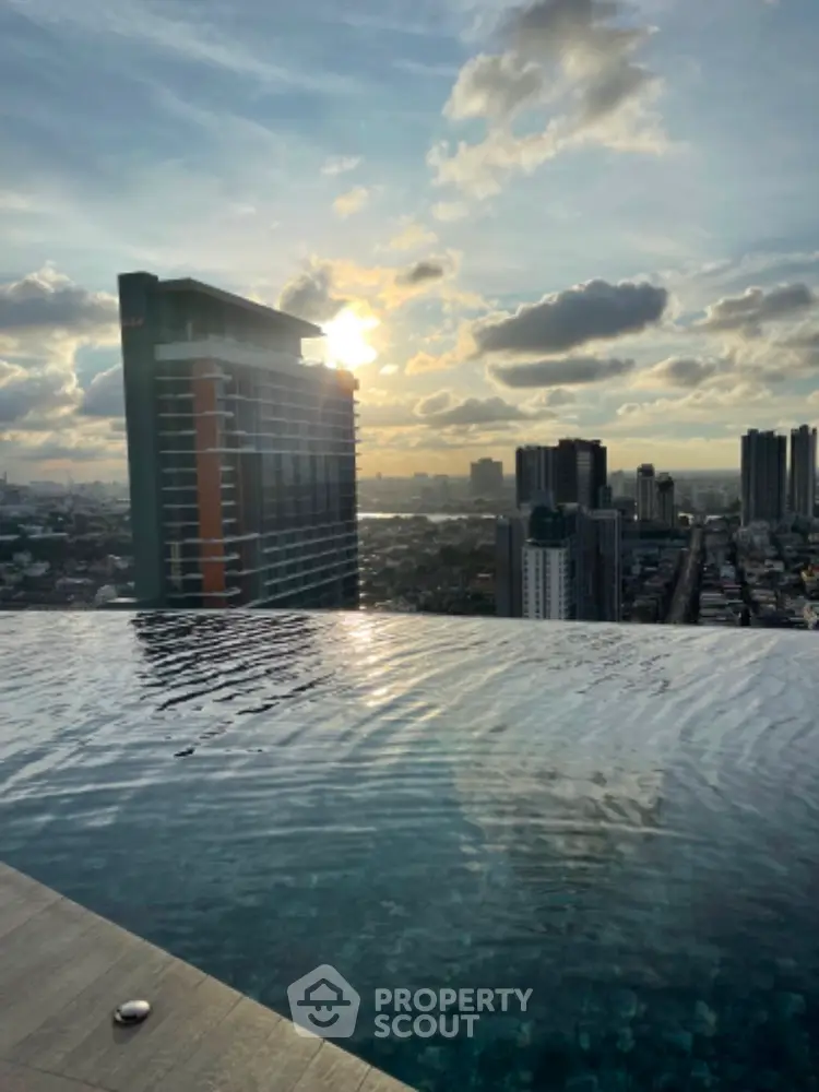 Stunning rooftop infinity pool with breathtaking city skyline view at sunset.