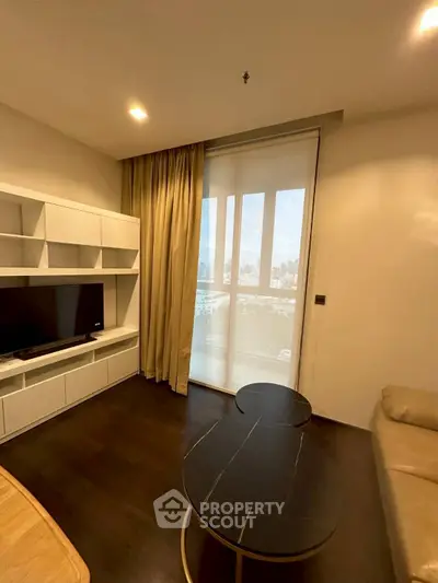 Modern living room with city view, featuring sleek furniture and large window for natural light.
